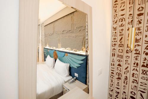 a bedroom with a window with a bed in it at Sultan Pyramids View INN in Cairo