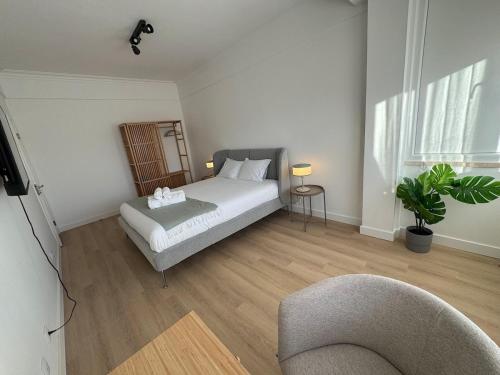 a bedroom with a bed and a chair in it at The Crow Ajuda Apartment I in Lisbon