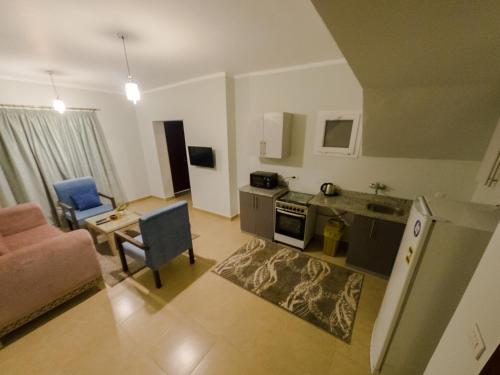 a kitchen and living room with a couch and a table at Blue Residence Dahab in Dahab