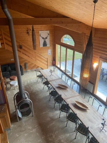 Cette grande chambre dispose d'une grande table et de chaises en bois. dans l'établissement LE GîTE DES DAINES, à Lavans-lès-Saint-Claude