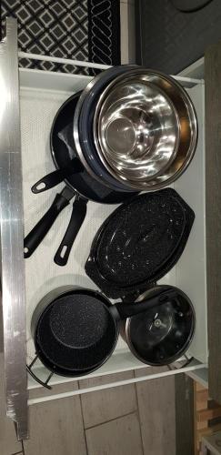a bunch of pans and utensils sitting on a shelf at DIJON Super appartement F1 bis climatisé mezzanine in Dijon