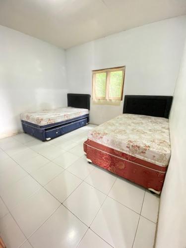 Кровать или кровати в номере Villa Bayu Lembang