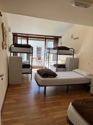 a room with three bunk beds in it at Albergue Azabache in Santiago de Compostela