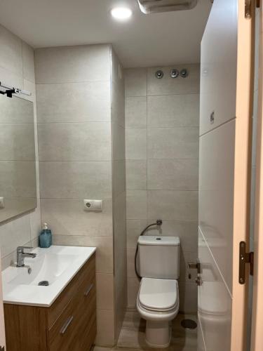 a bathroom with a white toilet and a sink at Albergue Azabache in Santiago de Compostela