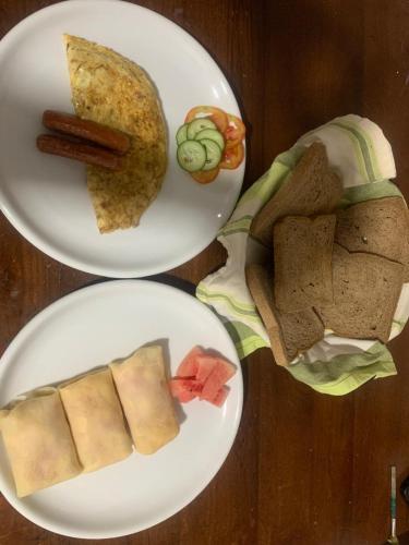 two plates of food on a wooden table at Madiha Venus in Matara