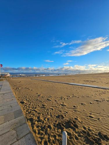 a sandy beach with footprints in the sand at Cattolica Apartments in Cattolica