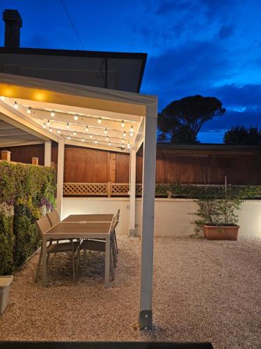 a picnic table under a pergola in a backyard at Cattolica Apartments in Cattolica