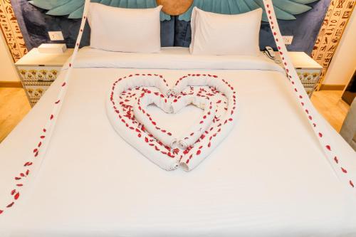 a bed with a heart made out of pillows at Sultan Pyramids View INN in Cairo