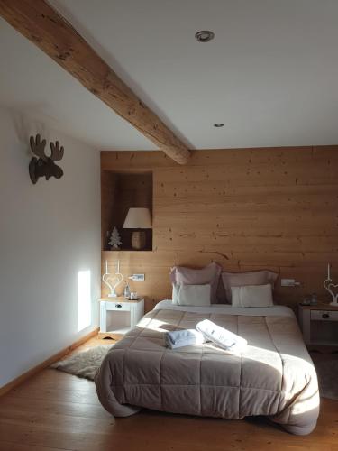 a bedroom with a large bed with wooden walls at La Petite Chapelle in Font-Romeu