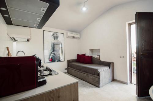 a kitchen and living room with a couch and a table at Agriturismo Re Tarquinio in Tuscania