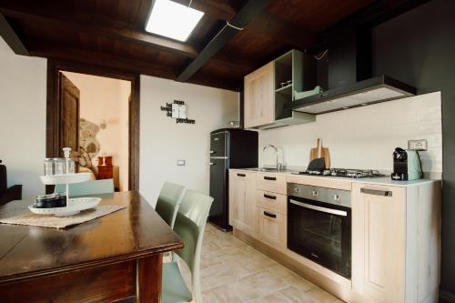 a kitchen with a table and a stove top oven at Agriturismo Re Tarquinio in Tuscania