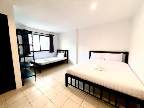 a bedroom with a large bed and a window at Patong Canal Villa 204 in Patong Beach