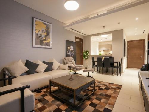 a living room with a couch and a table at Luxury 2BR in Sobha Hartland in Dubai