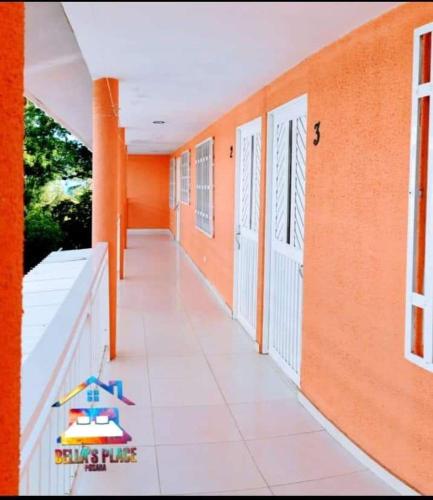 an empty hallway of a building with orange walls at Bellas Place in San Andrés