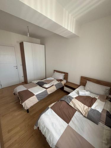 a bedroom with three beds in a room at ARIA Residence & Ѕра, Apartment 1-43, level 8 in Bitola