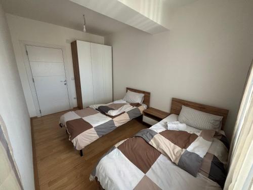 a room with two beds and a closet at ARIA Residence & Ѕра, Apartment 1-43, level 8 in Bitola