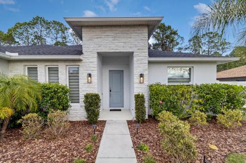 a house with a pathway leading to the front door at Sunny Stay Orlando Queen Room 5 with Shared Bath in Orlando