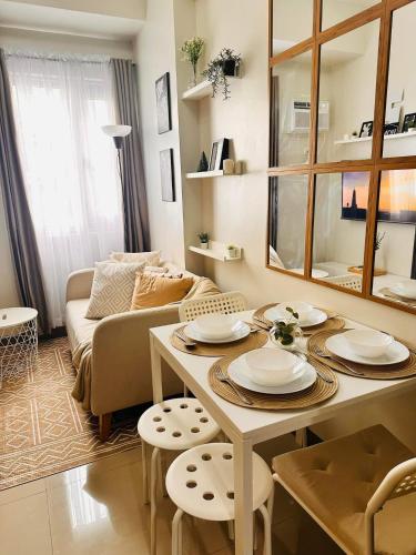 a living room with a table and a couch at The ARC Suites in Manila
