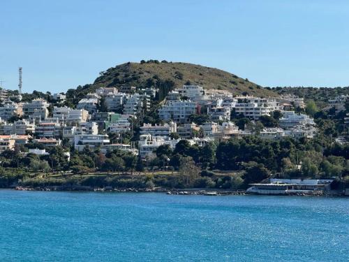 a group of houses on a hill next to the water at Hermes Riviera view in Athens