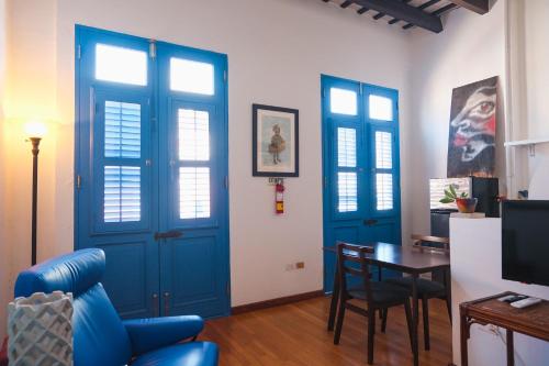 a living room with blue doors and a table at Caribe Rentals in San Juan
