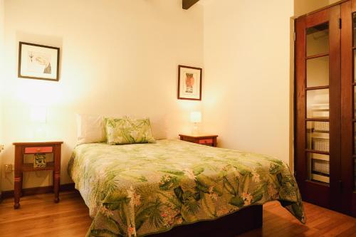 a bedroom with a bed and two night stands at Caribe Rentals in San Juan