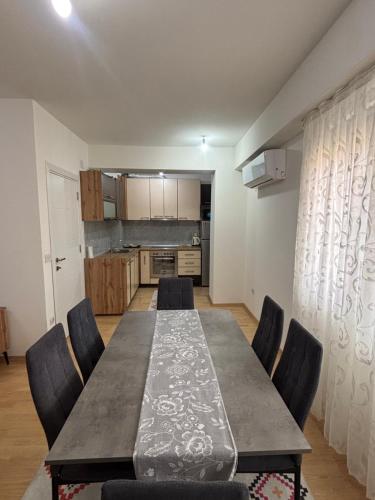a dining room with a long table and chairs at ARIA Residence & Ѕра, Apartment 1-43, level 8 in Bitola