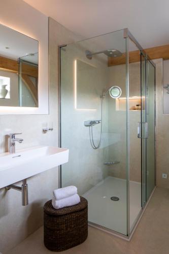 a bathroom with a glass shower and a sink at Woodlands Malvern B and B in Longley Green