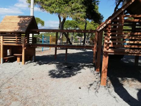 a wooden playground with a bench and a pavilion at Hermes Riviera view in Athens