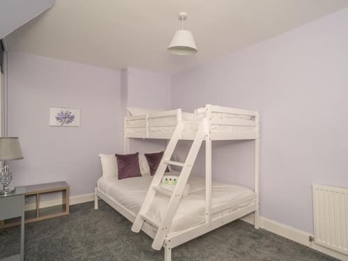 a white bunk bed with a ladder in a room at Charming Family House in Rosewell - Pass the Keys in Edinburgh