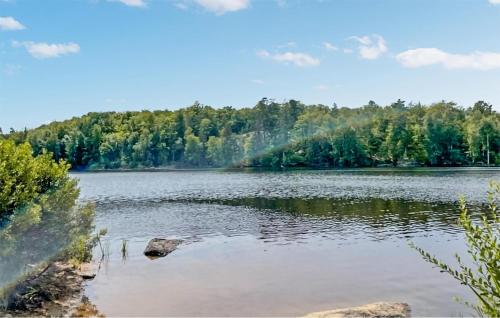 a view of a lake with trees in the background at 3 Bedroom Nice Home In Tving in Tving