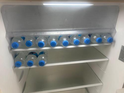 a bunch of water bottles in a refrigerator at Golden Acre Beach Villa-2 mins walk - Alleynes Bay in Saint James