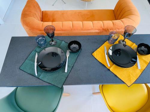 a table with plates and wine glasses on top of it at Kazandko : Location meublée Haute-Savoie in Arenthon