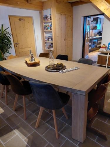 a wooden table in a room with chairs around it at Landhaus Algerhof in Abtenau