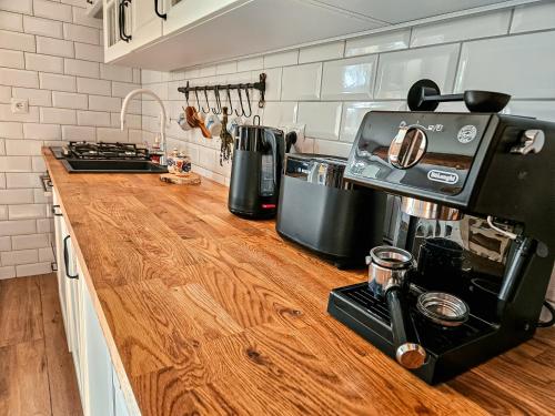 a kitchen with a wooden counter top with a coffee maker at Zakątek - Żabi Kraj in Mnich