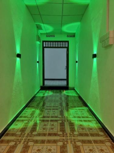an empty room with green lights on the floor at Gowsalya Guest House - Nilaveli Trincomalee in Trincomalee