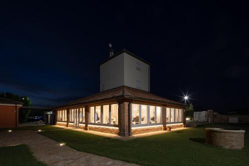 a building with a clock tower on top of it at night at Locanda Ca'Vejo srl in Megliadino San Vitale