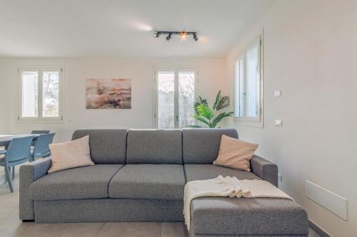 a living room with a gray couch and a table at Bellaria Palace - In the hearth of Motor Valley in Modena