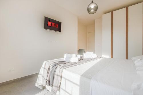 a bedroom with a bed with a clock on the wall at Bellaria Palace - In the hearth of Motor Valley in Modena