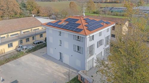 an overhead view of a building with solar panels on the roof at Bellaria Palace - In the hearth of Motor Valley in Modena