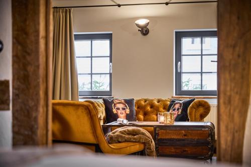 a living room with a couch and a table at Vollmer's Hof in Bad Berleburg