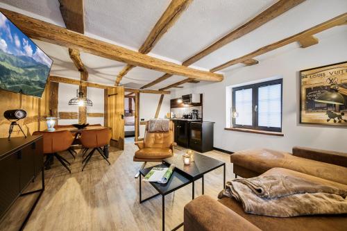 a living room with a couch and a table at Vollmer's Hof in Bad Berleburg