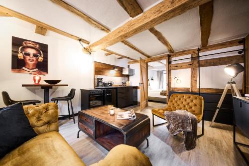 a living room with a couch and a table at Vollmer's Hof in Bad Berleburg