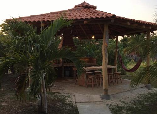 a wooden gazebo with a table and chairs at Casa de Madeira Atins 2 bedrooms in Atins