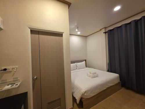 a small bedroom with a bed with two towels on it at ASAP Boutique Phuket in Ban Thalat Choeng Thale