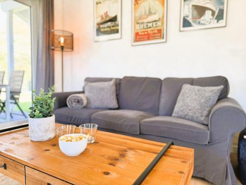 a living room with a couch and a coffee table at Fördezauber - Ruhiges Ferienhaus mit eingezäuntem Garten und Kamin in Bönstrup