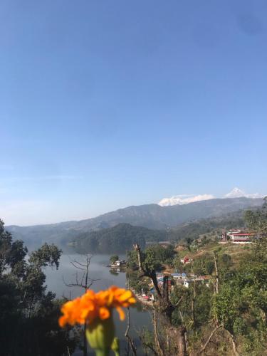 a view of a lake and mountains in the distance at Little Heaven Restaurant &guest House in Deorāli