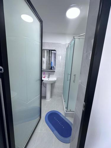 a bathroom with a glass shower and a sink at Lavington in Nairobi