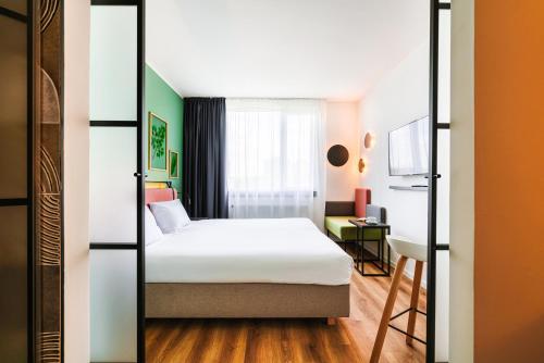 a hotel room with a bed and a desk at Hotel Convictus Cracovia for business & travellers in Kraków
