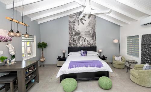 a bedroom with a large bed and a table and chairs at Mary's Boon Beach Resort & Spa in Simpson Bay