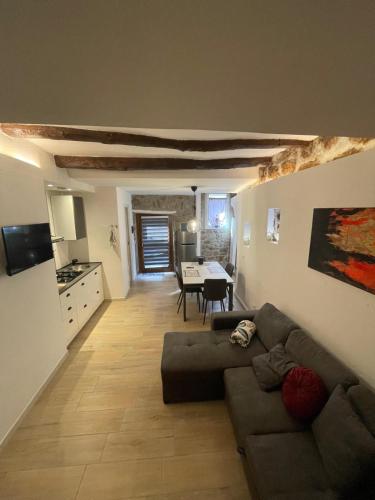 a living room with a couch and a table at La casetta di Giogi in Sutri